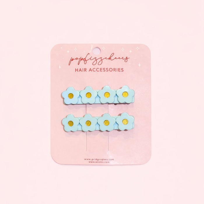 611fc05e3c4ce80992caae23_blue-flower-hair-clips-on-pink-background-copy_1771223563642.jpg