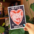 611fc05e3c4ce80992caae23_hugs-and-hisses-5x7-1_1768863084490.jpg